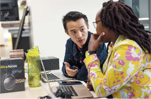  ??  ?? Larry Liu talks to his colleague at iHub, an incubation space for innovators in the upscale district of Nairobi. — Xinhua