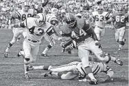  ?? ASSOCIATED PRESS FILE PHOTO ?? Broncos’ running back Floyd Little avoids a tackle against the Jets in 1969 in Denver. The Hall of Famer died Friday after a battle with cancer.