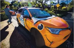  ??  ?? Sanders heads back to her specially painted car during a visit at a home in Los Gatos on Sunday.