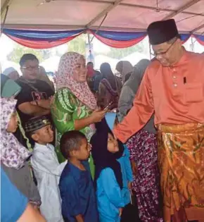  ?? [FOTO SHAMSUDIN HUSIN/BH] ?? Ismail Sabri bersalaman dengan kanak-kanak pada Majlis Mesra Rakyat dan Sambutan Hari Raya peringkat Wilayah KETENGAH 2017 di Dungun, semalam.