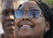  ?? ?? Sarah H. Jackson’s sunglasses reflect the Emmett Till statue during its unveiling Friday in Greenwood, Miss.
