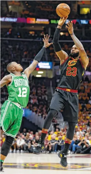  ?? THE ASSOCIATED PRESS ?? The Cleveland Cavaliers’ LeBron James shoots over Boston’s Terry Rozier during Game 4 of the NBA Eastern Conference finals Monday. James scored 44 points as the Cavs won 111-102.