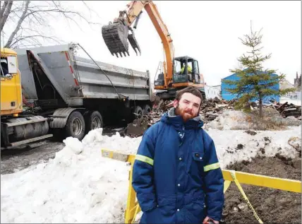  ?? SHARON MONTGOMERY-DUPE - CAPE BRETON POST ?? Chris Reid stands outside the apartment building at 417 9th St. in New Waterford where he was the lone tenant as debris from the building was being carted away Monday. Reid said a water pipe that burst in his bedroom saved his life early Sunday morning...