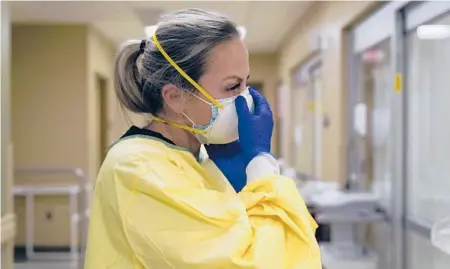  ?? JEFF ROBERSON/AP ?? RN Chrissie Burkhiser prepares to treat a COVID-19 patient last November in the ER at Scotland County Hospital in Memphis, Missouri.