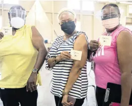  ?? GLADSTONE TAYLOR/ MULTIMEDIA PHOTO EDITOR ?? (From left) Delroy Pottinger, Roma Binns and Andrea Francis moments after receiving their dose of the Oxford-AstraZenec­a COVID-19 vaccine at the Mona Ageing and Wellness Centre on Sunday.