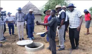  ?? ?? Misheck Mlambo (holding a cellphone) explaining how the biogas digester works in Chipinge, recently