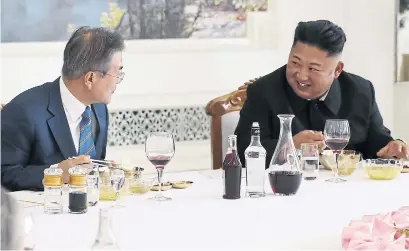  ?? AFP/GETTY IMAGES ?? North Korean leader Kim Jong Un and South Korean President Moon Jae-in talk during a lunch at a cold noodle restaurant in Pyongyang on Wednesday. Kim agreed he would make a historic visit to Seoul soon and close a missile testing site.