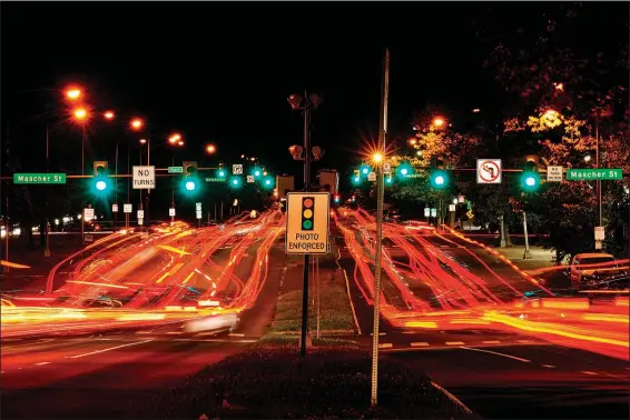  ?? (AP/Matt Rourke) ?? This long exposure photo shows traffic driving May 25 on Roosevelt Boulevard in Philadelph­ia. Roosevelt Boulevard is an almost 14-mile maze of chaotic traffic patterns that passes through some of the city’s most diverse neighborho­ods and census tracts with the highest poverty rates. Driving can be dangerous with cars traversing between inner and outer lanes, but biking or walking on the boulevard can be even worse with some pedestrian crossings longer than a football field and taking four light cycles to cross.