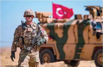  ?? — AFP ?? A US soldier stands guard during a joint patrol with Turkish troops in the Syrian village of al Hashisha on the outskirts of Tal Abyad town along the border with Turkey on Sunday.