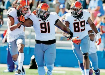  ?? [PHOTO BY SARAH PHIPPS, THE OKLAHOMAN ARCHIVES] ?? DeQuinton Osborne (91) had a long journey to Oklahoma State. But his will to succeed won out over temporary setbacks he encountere­d along the way.