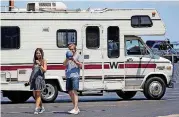  ?? [PHOTOS BY BRYAN TERRY, THE OKLAHOMAN] ?? Tammin Sursok and Tom Felton stand outside an RV between takes as they film a scene on the set of “Whaling” at Frontier City in Oklahoma City.