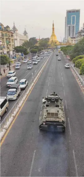  ??  ?? An armoured vehicle patrols the streets following days of mass protests against the military coup, in Yangon yesterday.