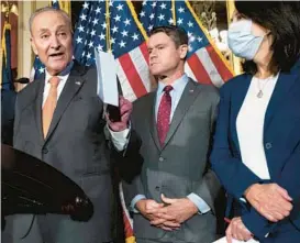  ?? SAUL LOEB/GETTY-AFP ?? Senate Majority Leader Chuck Schumer, D-N.Y., left, speaks Wednesday alongside Sens. Todd Young, R-Ind., and Maria Cantwell, D-Wash., at the U.S. Capitol.