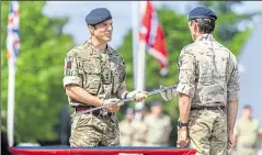  ??  ?? The sword is presented to the regiment in a ceremony at Invicta Park Barracks