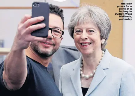  ?? Picture: DARREN STAPLES/PA ?? Mrs May poses for a selfie at a factory in Dudley, West Midlands, yesterday