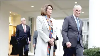  ?? EVAN VUCCI/AP ?? U.S. Rep. Nancy Pelosi, D-Calif., and Senate Minority Leader Chuck Schumer, D-N.Y., leave the White House on Wednesday after a meeting with President Donald Trump on border security.