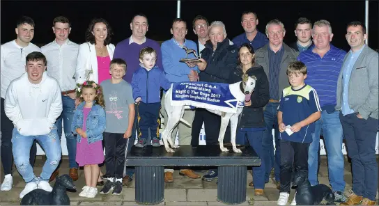  ??  ?? Chairman of the Annascaul GAA Club, Paudie Moriarty, presents the winning trophy to winning Owner/Trainer Chris Houlihan (Ballyduff) after Cashen Sammer won the Annascaul GAA Buster Final at the Kingdom Stadium on Saturday night. Included are the...