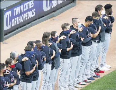  ?? JIM MONE — THE ASSOCIATED PRESS ?? Indians players line up for the national anthem before their game against the Twins on July 31.