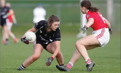  ??  ?? Donoughmor­e’s Jenny Drew Dinan takes on Galtee Rovers’ Eimear Gleeson during last weekend’s Munster Junior Club Championsh­ip Final in Mallow. Photo: Eric Barry