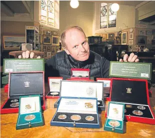  ?? Pictures: Steve MacDougall. ?? Auctioneer Nick Burns with some of the coins at Lindsay Burns and Company, Perth, and a close-up of one of the sets.