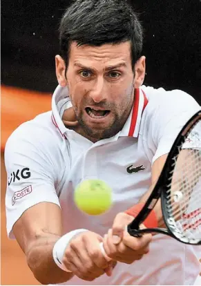  ?? — AFP ?? Hard work: Novak djokovic returns a shot to Taylor Fritz during the first round of the Italian Open on Tuesday.