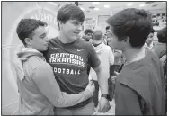  ?? NWA Democrat-Gazette/DAVID GOTTSCHALK ?? Darin Davenport (center) is congratula­ted Wednesday after signing a letter of intent to play football Wednesday at Southside High School in Fort Smith.