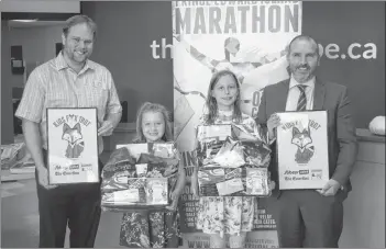  ?? DAVE STEWART/THE GUARDIAN ?? Eva Lyn Connor, 6, second from left, and Ella Hanus, 10, are the two winners of a contest conducted by the P.E.I. Marathon and The Guardian to name a new kids event and give it a logo. It will now be called the Kids Fox Trot. Helping to promote the event are Matt Gauthier, left, Sobeys Extra store manager, and Colin Sly, regional sales manager of The Guardian and the Journal Pioneer.