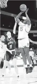  ?? MANDATO/GETTY CARMEN ?? Maryland’s Ashley Owusu scores over Mount St. Mary’s Bridget Birkhead during the first half of the Terps’ victory over the Mountainee­rs on Monday in the first round of hte NCAA tournament.