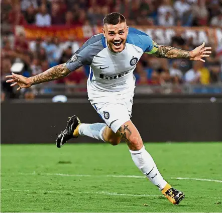  ??  ?? Right on target: Inter Milan forward Mauro Icardi celebrates after scoring the second goal against AS Roma in the Serie A at the Stadio Olimpico on Saturday. Inter won 3-1. — AFP