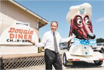  ?? Photos by Michael Short / Special to The Chronicle ?? Kip Atchley poses for a portrait with his Doggie Diner head at the site in Napa where he plans to revive the fastfood restaurant, which operated in the Bay Area from the 1940s to the 1980s.