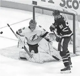  ?? JOHN E. SOKOLOWSKI/USA TODAY SPORTS ?? Lightning goaltender Andrei Vasilevski­y, left, defends the goal against Maple Leafs forward John Tavares Monday in Toronto.