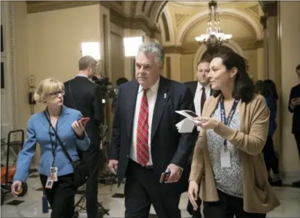  ?? J. SCOTT APPLEWHITE — THE ASSOCIATED PRESS ?? Rep. Peter King, R-N.Y., leaves the House chamber after the House gave a significan­t boost to President Donald Trump’s promise to cut taxes, narrowly passing a GOP budget that shelves longstandi­ng concern over federal deficits in favor of a rewrite of...