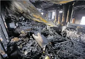  ?? ?? The ruins of a home in Chimayó on Monday after a fire engulfed the structure Saturday. Two young girls died in the blaze.