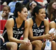  ?? JOHN MINCHILLO — THE ASSOCIATED PRESS ?? UConn’s Kia Nurse (11), Napheesa Collier (24), and Gabby Williams, right, smile on the bench in the second half of the team’s 96-49victory over Cincinnati.