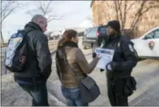  ?? MARY ALTAFFER — THE ASSOCIATED PRESS ?? United States Park Police officer Fernandez, right, inform tourist that the Statue of Liberty is closed, Saturday in New York.