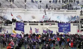  ?? — AP ?? Two wrongs not a right: A file photo showing the rioters storming the Capitol in Washington. Deplatform­ing a sitting president undermined public trust in Twitter for half of America, says Musk.