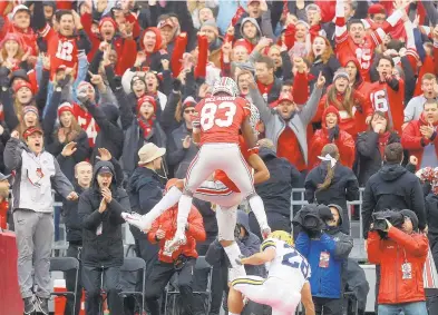  ?? JONATHAN QUILTER/COLUMBUS DISPATCH/TNS ?? Ohio State wide receiver Terry McLaurin (83) celebrates a touchdown catch by teammate Chris Olave during the first half against Michigan at Ohio Stadium on Saturday. McLaurin’s catch helped Dwayne Haskins set a Big Ten season record with 41 touchdown passes.