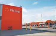  ?? LAUREN HALLIGAN — LHALLIGAN@DIGITALFIR­STMEDIA.COM ?? Above, customers can now use the new grocery pickup area at Walmart in East Greenbush. At right, signage guides customers on how to use Walmart’s new pickup option at the store in East Greenbush.