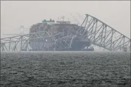  ?? MATT ROURKE — THE ASSOCIATED PRESS ?? A container ship rests against the wreckage of the Francis Scott Key Bridge in Baltimore, Md., on Thursday.