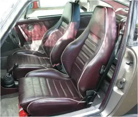  ??  ?? Burgundy leather seats with white piping brighten up the interior