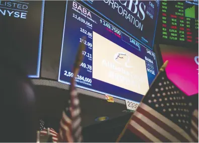  ?? MICHAEL NAGLE / BLOOMBERG FILES ?? A monitor displays Alibaba Group Holding Ltd. signage on the floor of the New York Stock Exchange. Investors are worried how the blacklist will apply hit shares in U.S.-listed Chinese tech stalwarts Alibaba and Tencent Holdings.