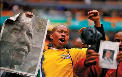  ?? KAI PFAFFENBAC­H / REUTERS ?? People start singing as they arrive for a mass memorial service for former South African president Nelson Mandela in Johannesbu­rg, South Africa, on Tuesday. He will be buried in his home village of Qunu on Sunday.