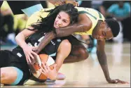  ?? Mark Lennihan / Associated Press ?? The Liberty’s Kia Nurse and Storm’s Natasha Howard fight for a loose ball in the first half of New York’s 96-80 loss on Monday.