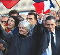  ??  ?? FRANCOIS FILLON, former French prime minister, member of The Republican­s political party and 2017 presidenti­al election candidate of the French center-right and his wife Penelope (L) attend a meeting at the Trocadero square across from the Eiffel Tower...