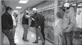  ?? Donnis Hueftle-Bullock ?? Pete Cummingham, president of the Ansley School board, elbow bumps with Lt. Gov. Mike Foley on the tour of the school. Looking on are Chris Hogg, Gordon Goodman, Superinten­dent Cathie Jo Mills and Trent Fecht.