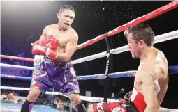  ??  ?? Donnie Nietes, left, knocks down Juan Carlos Reveco during their IBF flyweight title bout in Inglewood, California. Nietes won by a seventh-round stoppage. (Jhay Otamias)