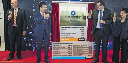  ?? Picture / Greg Bowker ?? It was smiles all round as China Constructi­on Bank’s Auckland branch was opened this month. Herald graphic
