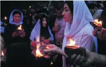  ?? Ari Jalal/ Reuters ?? Iraqi Yazidis during a ceremony to celebrate the Yazidi New Year at Lalish temple in Shikhan in Dohuk province.