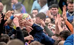  ??  ?? The Shrovetide football is passed through the crowds during this raucous annual celebratio­n, which pitches two teams against each other.