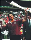  ??  ?? Queensland captain Peter Slattery with the 1995 trophy.